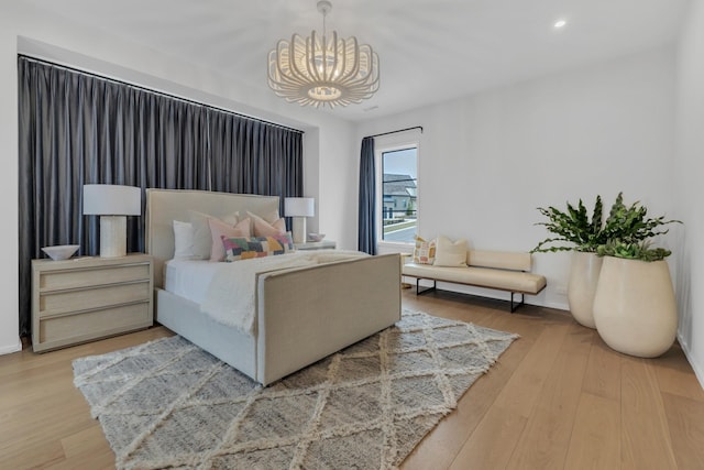 bedroom with a notable chandelier, recessed lighting, baseboards, and wood finished floors