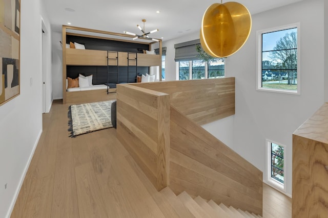 interior space with a notable chandelier, recessed lighting, baseboards, and wood finished floors