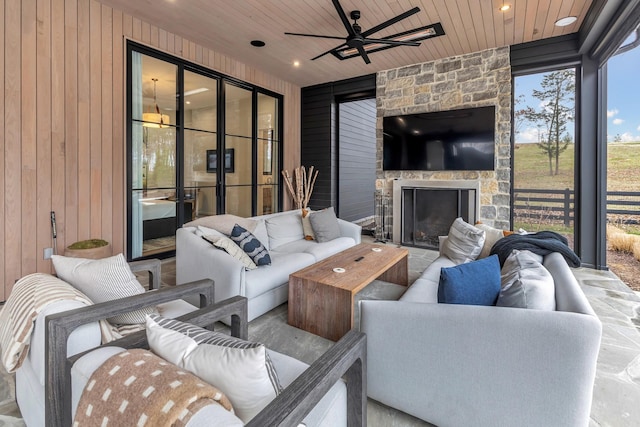 view of patio / terrace featuring an outdoor living space with a fireplace and ceiling fan