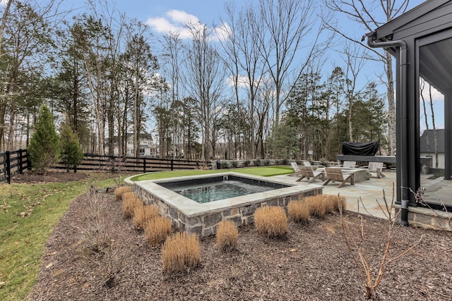 exterior space featuring a patio area, an in ground hot tub, and fence