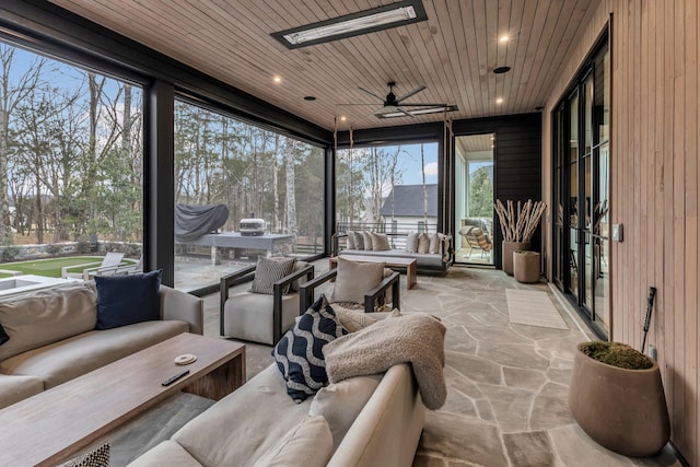 sunroom with wood ceiling and ceiling fan