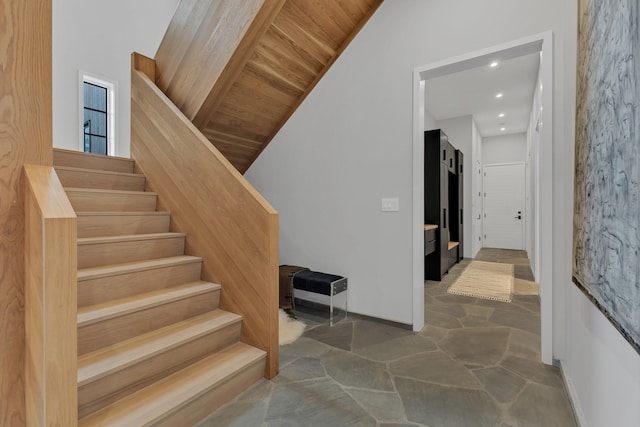 stairs featuring stone flooring, recessed lighting, wood ceiling, and baseboards