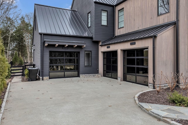 exterior space with metal roof, a patio area, and a standing seam roof