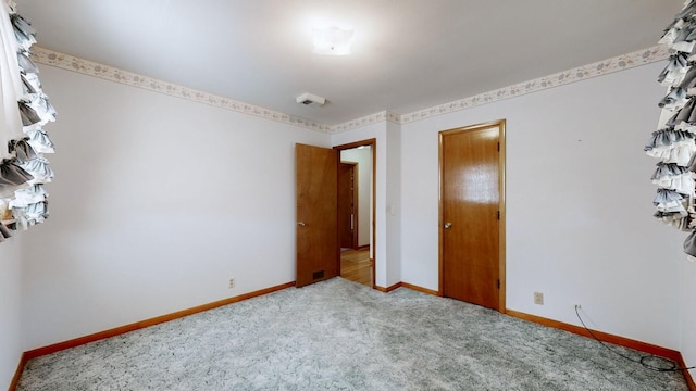 unfurnished bedroom featuring baseboards and carpet floors