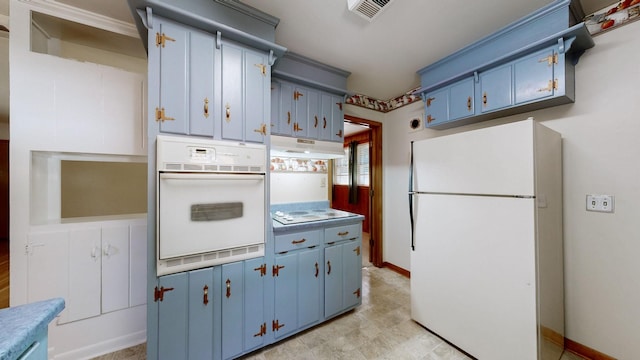 kitchen featuring blue cabinets, visible vents, white appliances, and under cabinet range hood