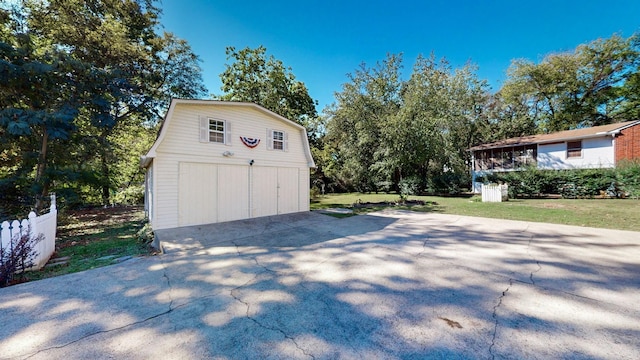 garage featuring a garage and fence