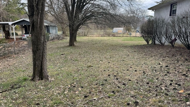 view of yard with a carport and fence