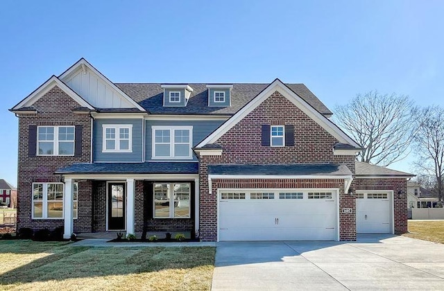 view of front of property with brick siding, driveway, a front lawn, and board and batten siding