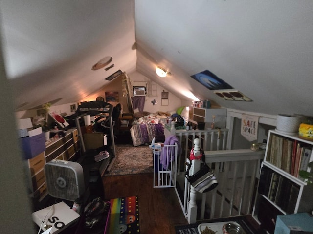 additional living space featuring wood finished floors and vaulted ceiling