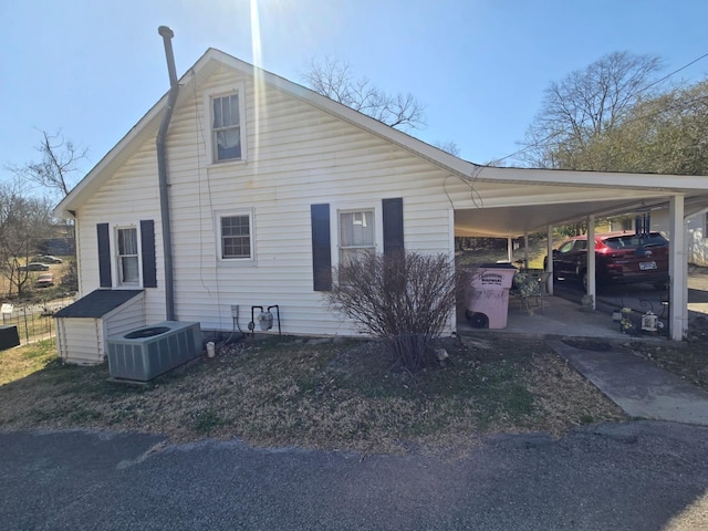 view of property exterior featuring a carport and central air condition unit