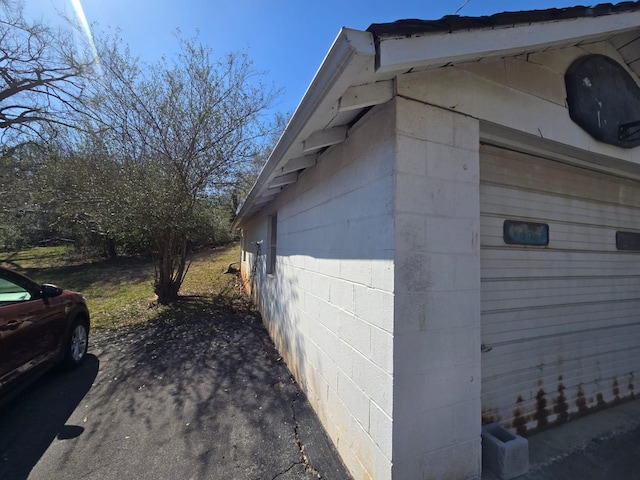 view of side of home featuring concrete block siding