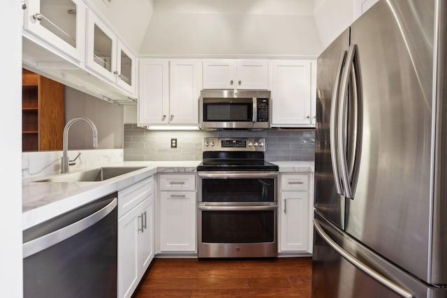 kitchen with white cabinets, appliances with stainless steel finishes, and a sink