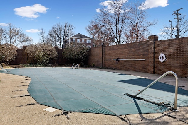 view of swimming pool featuring a fenced backyard and a patio area