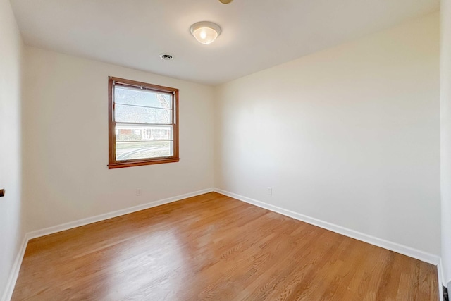 unfurnished room featuring light wood-style floors and baseboards