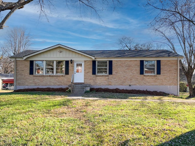 ranch-style home featuring brick siding and a front lawn