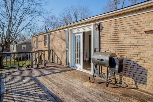 wooden terrace featuring area for grilling