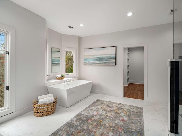 full bathroom with recessed lighting, visible vents, a soaking tub, and marble finish floor