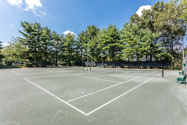 view of tennis court featuring fence