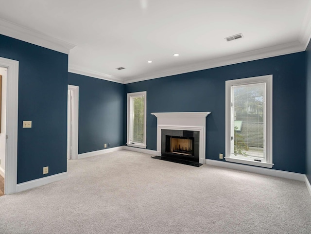 unfurnished living room featuring baseboards, visible vents, carpet floors, and ornamental molding