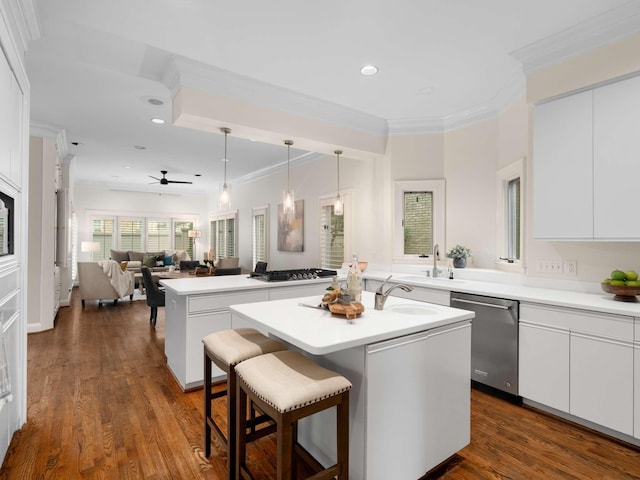 kitchen with dark wood-style flooring, dishwasher, an island with sink, and ornamental molding