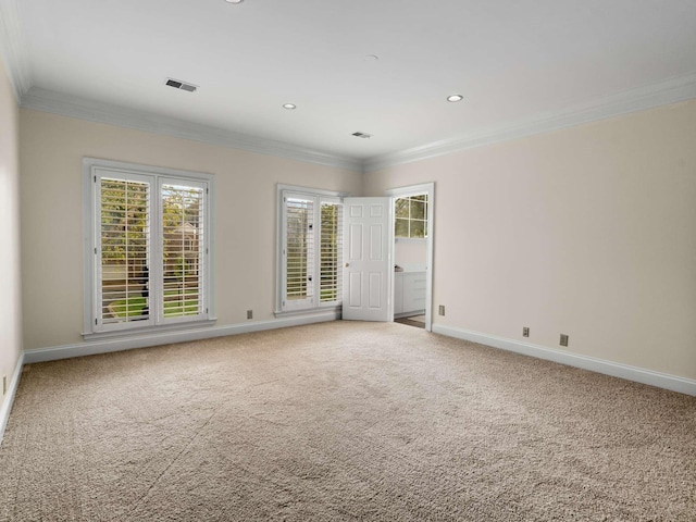 empty room with carpet, visible vents, baseboards, recessed lighting, and ornamental molding