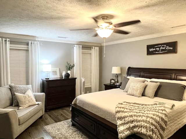 bedroom with ceiling fan, a textured ceiling, wood finished floors, and crown molding