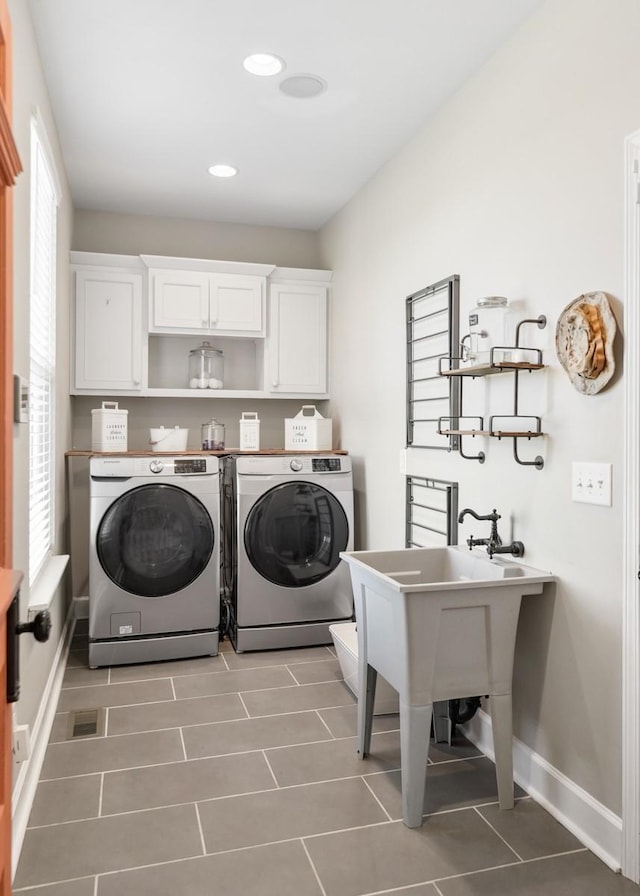 laundry room with recessed lighting, baseboards, cabinet space, and washer and clothes dryer