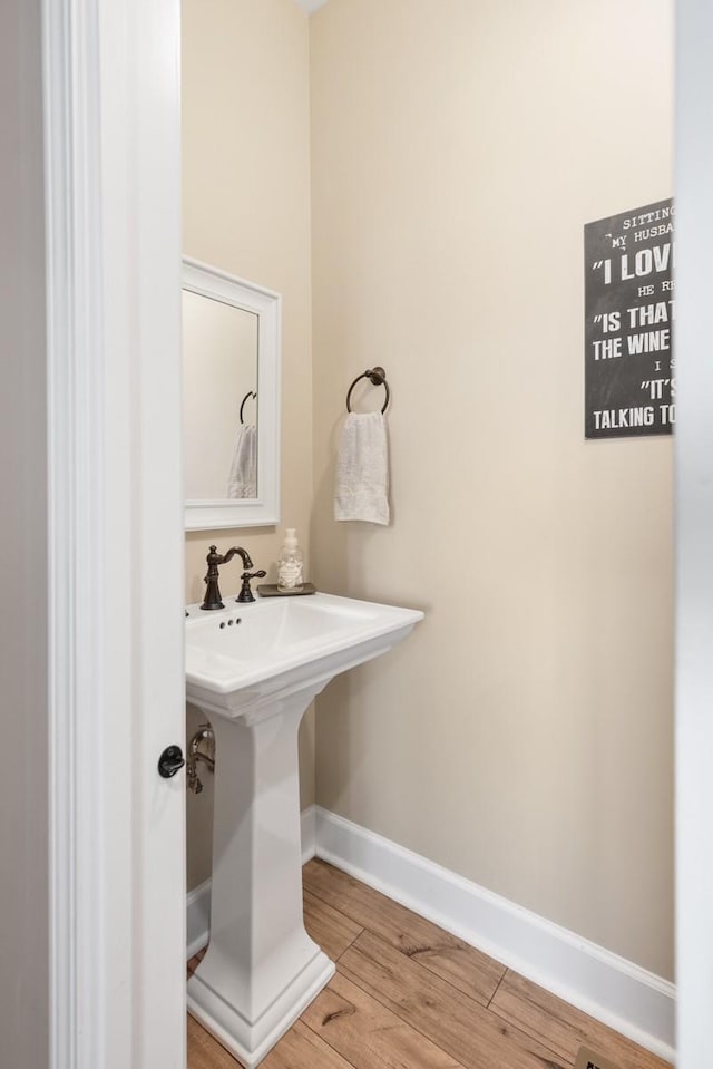 bathroom featuring baseboards and wood finished floors