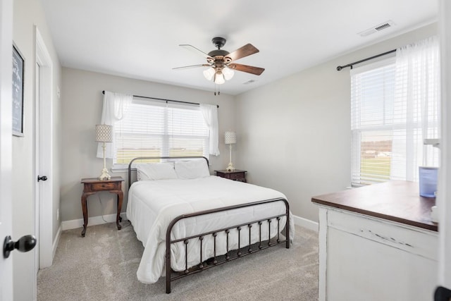 bedroom featuring light carpet, visible vents, ceiling fan, and baseboards