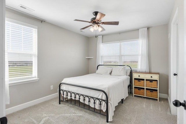 bedroom with visible vents, multiple windows, baseboards, and carpet flooring