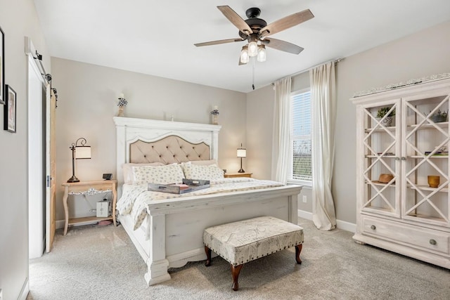 bedroom featuring baseboards, light carpet, and a ceiling fan