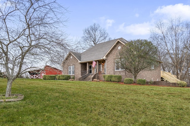 view of front of home with a front lawn and brick siding
