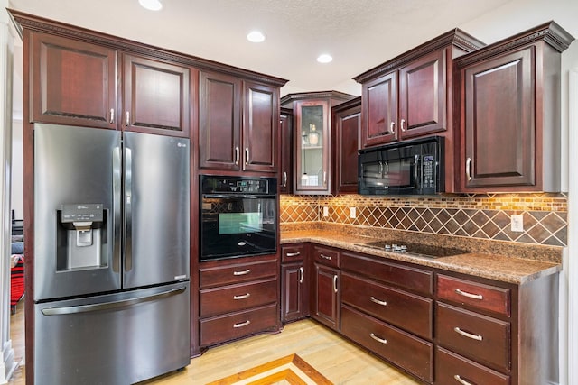 kitchen with black appliances, tasteful backsplash, recessed lighting, and light wood-type flooring