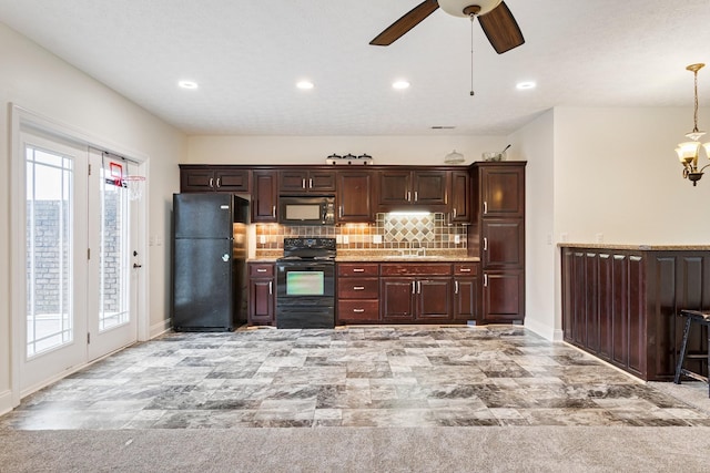 kitchen with a sink, decorative backsplash, black appliances, light countertops, and ceiling fan with notable chandelier