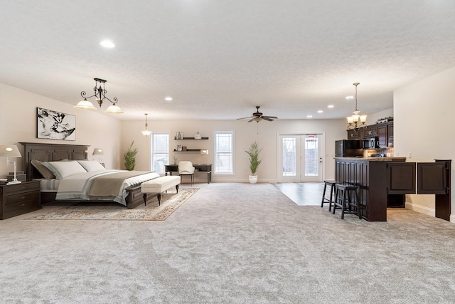 bedroom featuring recessed lighting, black refrigerator, light colored carpet, and access to exterior