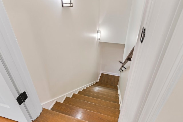 staircase with baseboards and hardwood / wood-style flooring