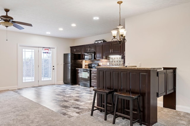 kitchen featuring baseboards, ceiling fan, black appliances, dark brown cabinetry, and backsplash