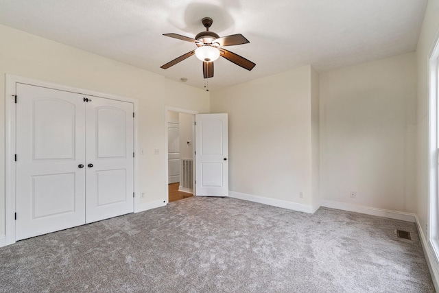 unfurnished bedroom featuring a closet, visible vents, baseboards, and carpet