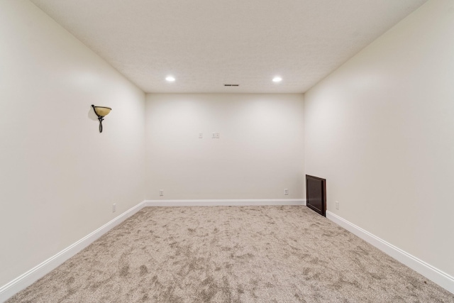 empty room with recessed lighting, visible vents, baseboards, and carpet flooring