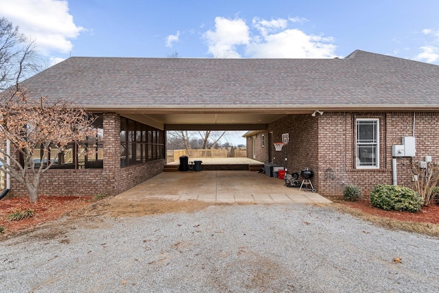 view of car parking featuring an attached carport and gravel driveway