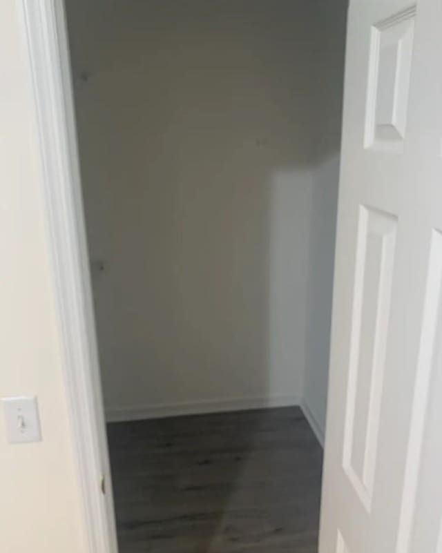 interior space with wood finished floors and baseboards