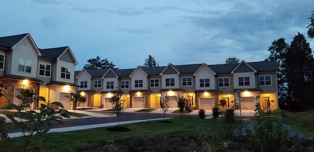 rear view of property featuring an attached garage