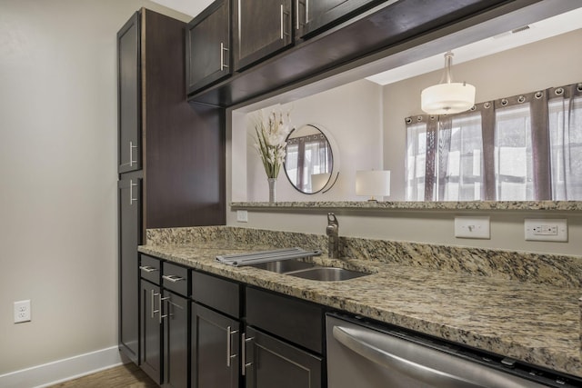 kitchen with light stone counters, baseboards, a sink, dark brown cabinetry, and stainless steel dishwasher