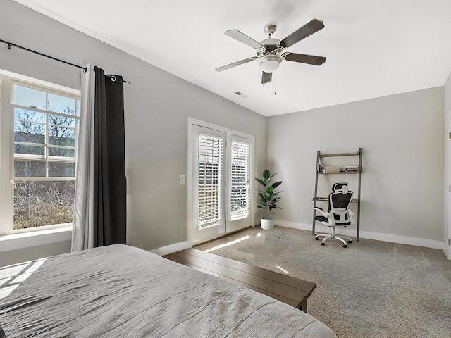 carpeted bedroom featuring visible vents, baseboards, ceiling fan, and access to outside