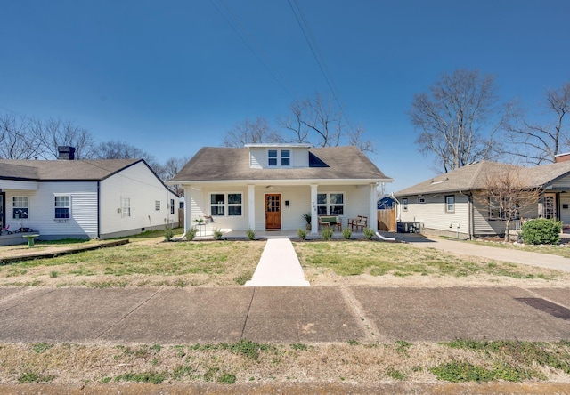 bungalow-style home featuring a porch and a front lawn