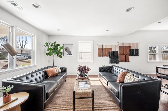 living room with recessed lighting, wood finished floors, visible vents, and baseboards