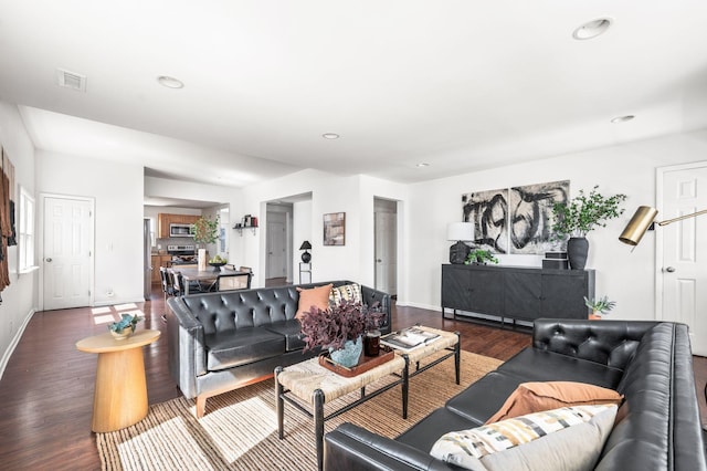 living area with recessed lighting, wood finished floors, visible vents, and baseboards