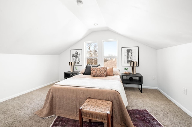 carpeted bedroom with baseboards and lofted ceiling