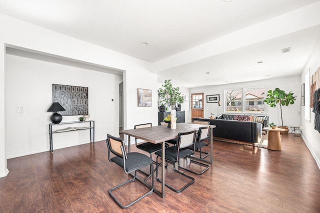 dining area featuring visible vents, wood finished floors, and baseboards