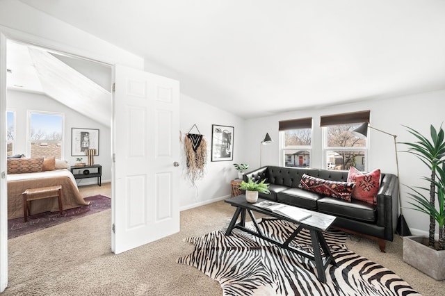 carpeted living room featuring vaulted ceiling, baseboards, and a wealth of natural light